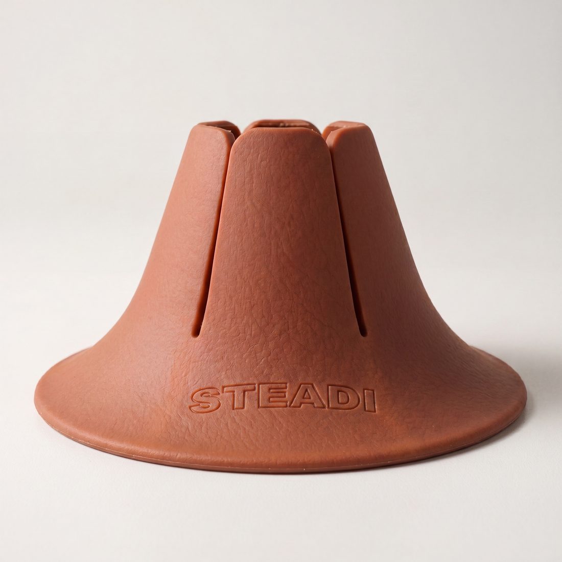 A close studio photograph of a terracotta Steadi on a white ground, showing the wide flared base and the moulded STEADI mark.